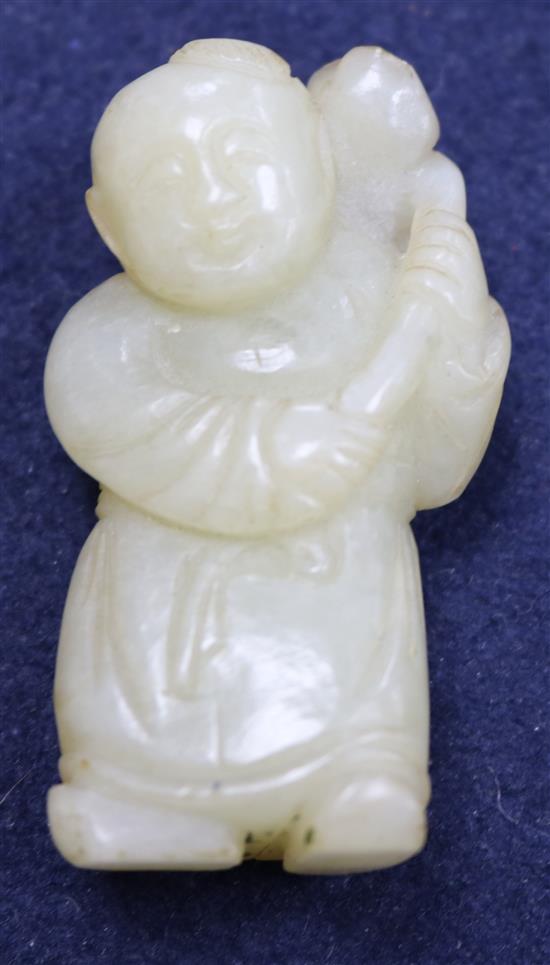 A Chinese pale greenish-yellow jade figure of a boy holding a sprig of lotus, 18th/19th century, 5.9cm